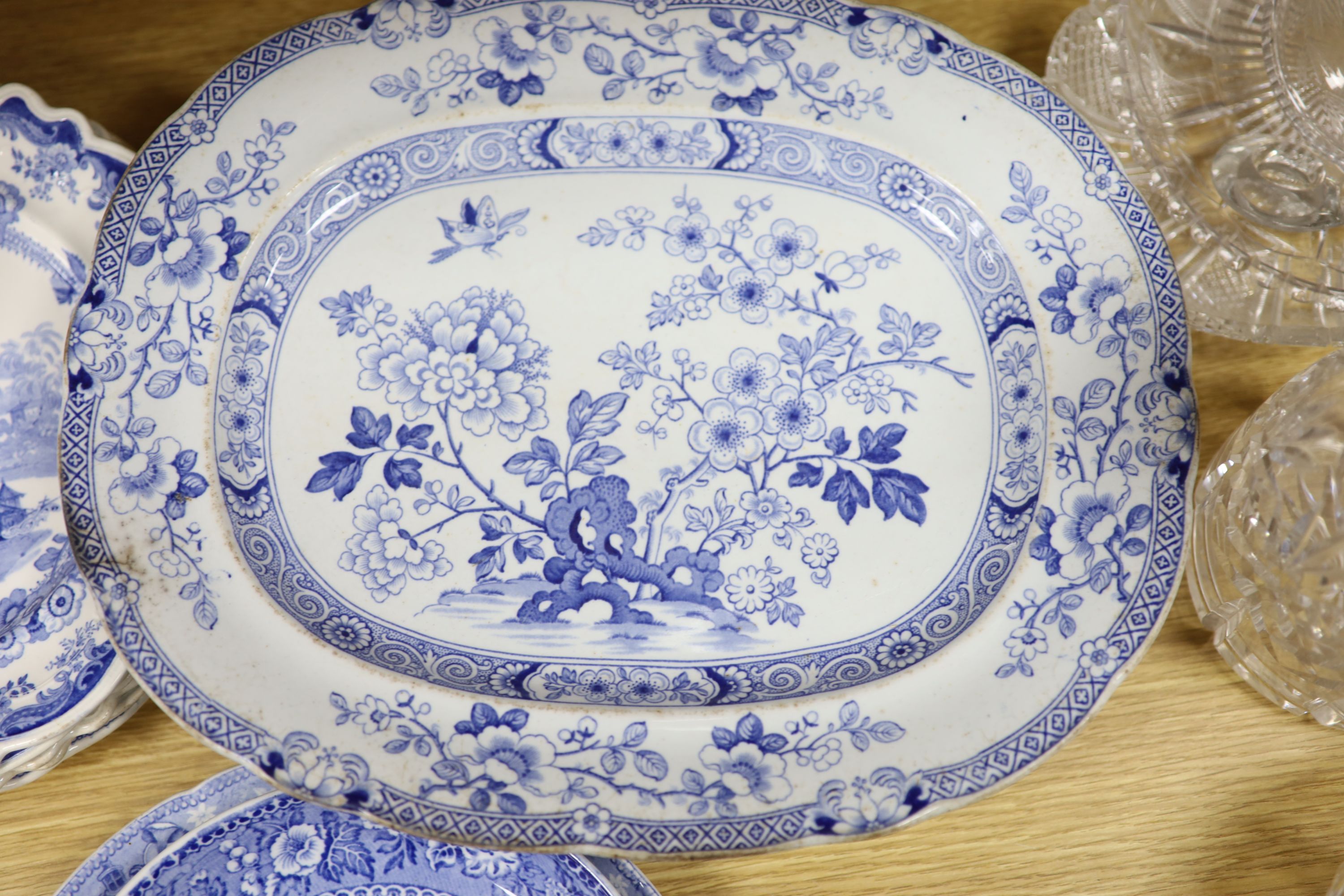 A collection of 19th and 20th century blue and white pottery plates and dishes